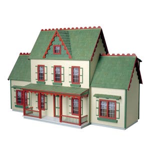 Finished 1-inch scale Vermont Farmhouse Jr. Dollhouse Kit by Real Good Toys. 2-story addition attached on each side and sold separately. Front view, painted green with red trim. Main house is 3-stories, 29.4 in H x 24.25 W. Kit sold unfinished.