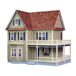 May include: A two-story dollhouse with a brown shingled roof, white trim, and a wraparound porch. The dollhouse has a light beige exterior with blue shutters and windows. The porch has a white railing and a flower box with colorful flowers.