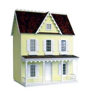 Finished 1-inch scale Vermont Farmhouse Jr. Dollhouse Kit by Real Good Toys. Front view, painted yellow with white trim. Milled MDF exterior, front porch, wooden roof shingles, shutters, window boxes. 29.4 in. tall x 24.25 wide. Kit sold unfinished.