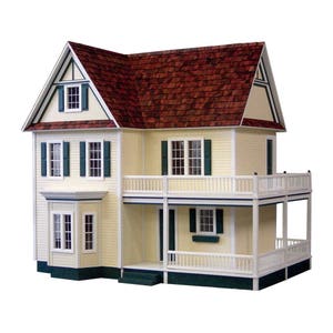 Front view of finished 1 inch scale Victorias Farmhouse Dollhouse Kit by Real Good Toys. 3 story farmhouse 33 in. tall x 34.5 wide. Milled clapboard exterior, wrap around porch, wooden roof shingles. Side opening access. Kit is unfinished.