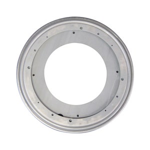 May include: A silver metal swivel base with a circular opening in the center. The base has a series of small holes around the outer edge.