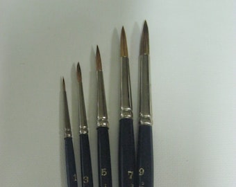 May include: A set of six paint brushes with black handles and gold lettering. The brushes are labeled with numbers 1, 3, 5, 7, and 9. The text on the handles reads "SOC.INT. CAN.MTL. 68 SABELINE".