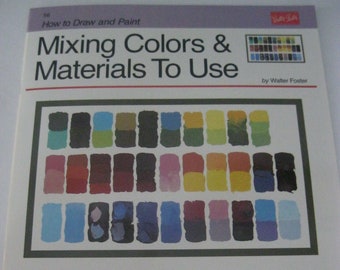May include: A book titled "Mixing Colors & Materials To Use" by Walter Foster. The book cover features a color chart with various shades of blue, green, red, yellow, orange, and purple.