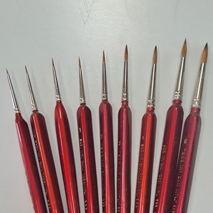 May include: Set of ten red handled paint brushes with gold lettering. The brushes are labeled with the size and brand name "SOC. INT. CAN. MTL. 338 SABLE".
