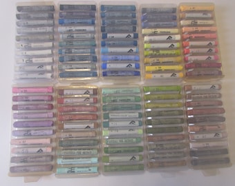 May include: A set of 10 plastic containers filled with pastel sticks. Each container has a label with a number and the text "PASTELLI PER ARTISTI" or "FERDANDO COLOR".