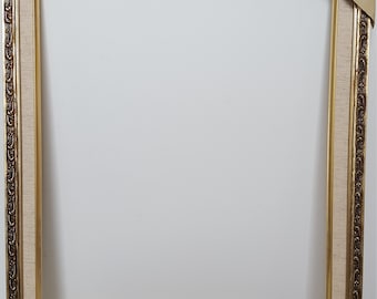 May include: A gold picture frame with a white mat and ornate detailing. The frame is 16x20 inches.