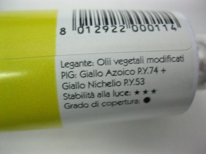 May include: A yellow tube of paint with the text "Legante: Olii vegetali modificati PIG: Giallo Azoico P.Y.74 + Giallo Nichelio P.Y.53 Stabilit&agrave; alla luce: ★★★ Grado di copertura:" printed on the side.