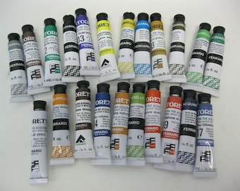 May include: A collection of 17 watercolor paint tubes in various colors, labeled "Aquarello" and "Ferrari" with the volume of each tube listed as 5 ml or 1/4 fl. oz.