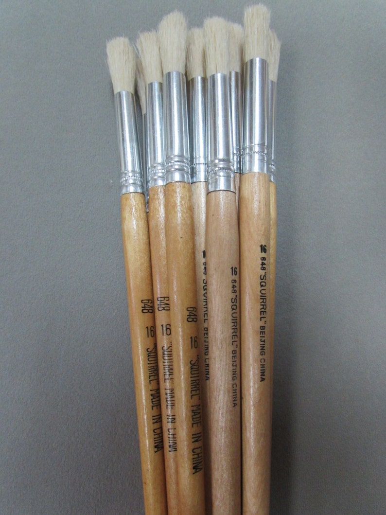May include: A set of ten paint brushes with wooden handles and silver ferrules. The brushes have white bristles and are labeled "648 SQUIRREL" and "MADE IN CHINA".