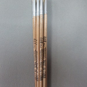 May include: Four wooden-handled paint brushes with white bristles. The handles are labeled "Squirrel" and "Made in China".
