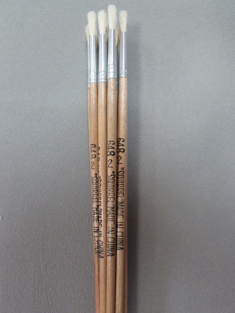 May include: Four wooden-handled paint brushes with white bristles. The handles are labeled "Squirrel" and "Made in China".