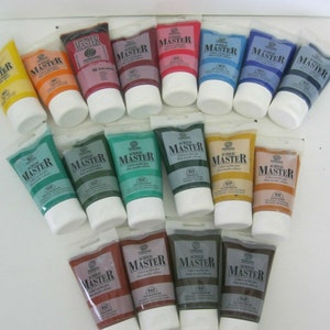 May include: A collection of 18 acrylic paint tubes in various colours, including yellow, orange, red, blue, green, brown, and grey. The tubes are labelled "Acrylic Master" and have a white cap.