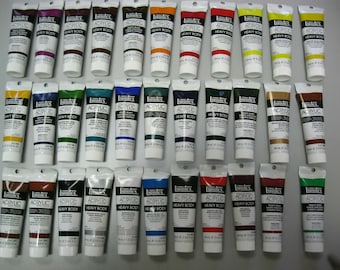 May include: A collection of 30 tubes of Liquitex Professional Acrylic Heavy Body paint. The tubes are arranged in three rows of ten, with each row containing a different color. The colors include red, orange, yellow, green, blue, purple, brown, black, white, and gray.