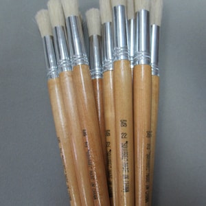 May include: A bundle of 10 round paint brushes with wooden handles and silver ferrules. The brushes are labeled "SQUIRREL" and "MADE IN CHINA".