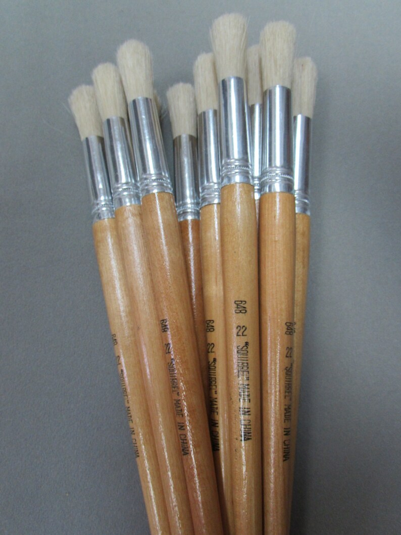May include: A bundle of 10 round paint brushes with wooden handles and silver ferrules. The brushes are labeled "SQUIRREL" and "MADE IN CHINA".