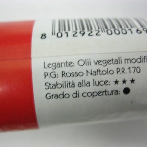 May include: A red paint tube with a white label. The label includes the text "Legante: Olii vegetali modificati", "PIG: Rosso Naftolo P.R.170", "Stabilit&agrave; alla luce: ★★★", and "Grado di copertura:".