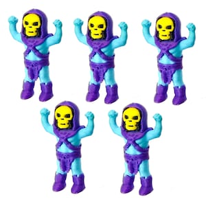 May include: Five identical small figurines of a skeletal character with a yellow skull head, a purple hood, purple chest armor, purple loincloth, and purple boots, with a light blue body, standing with arms raised in a flexed pose.