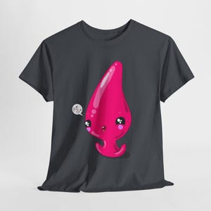 May include: A dark gray t-shirt with a pink cartoon character on the front. The character has a large, pink, teardrop-shaped body with a smiling face and large eyes. The character is saying "Pink you!" in a speech bubble.