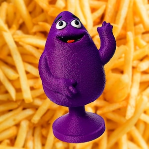 May include: A purple cartoon character with a big smile and a raised hand, standing against a background of golden chips.