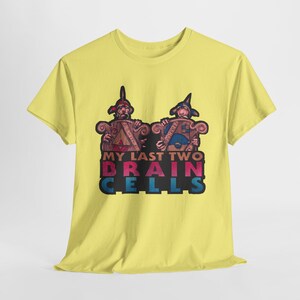 May include: Yellow t-shirt with a graphic of two cartoon characters in medieval armor holding shields. The text "My Last Two Brain Cells" is printed below the characters.