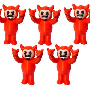 May include: Five small, red devil figurines with horns, a black mustache, and a white face. The figurines are in a standing position with their arms raised in a rock-and-roll gesture. The figures are made of plastic.