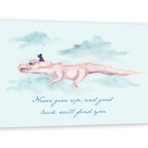 May include: A watercolour illustration of a pink dragon flying through the clouds with a small person riding on its back. The text "Never give up, and good luck will find you" is written below the dragon.