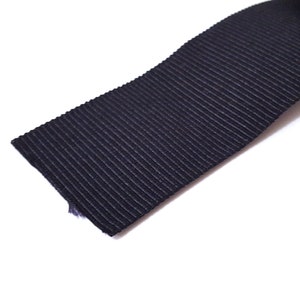 May include: Black ribbed elastic ribbon.