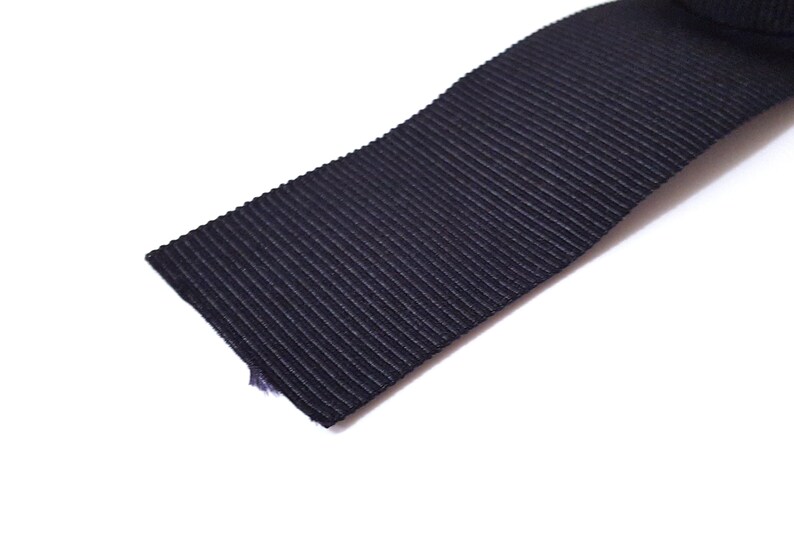 May include: Black ribbed elastic ribbon.