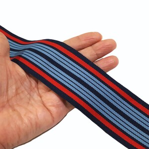 May include: Blue and red striped ribbon with a textured surface.