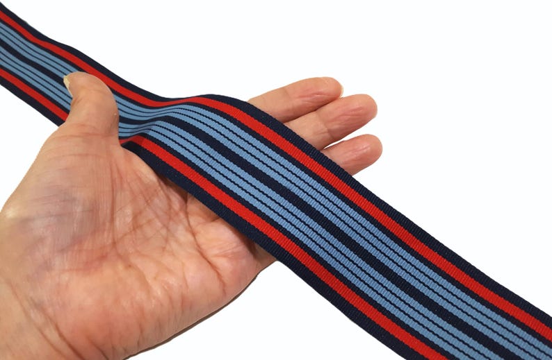 May include: Blue and red striped ribbon with a textured surface.