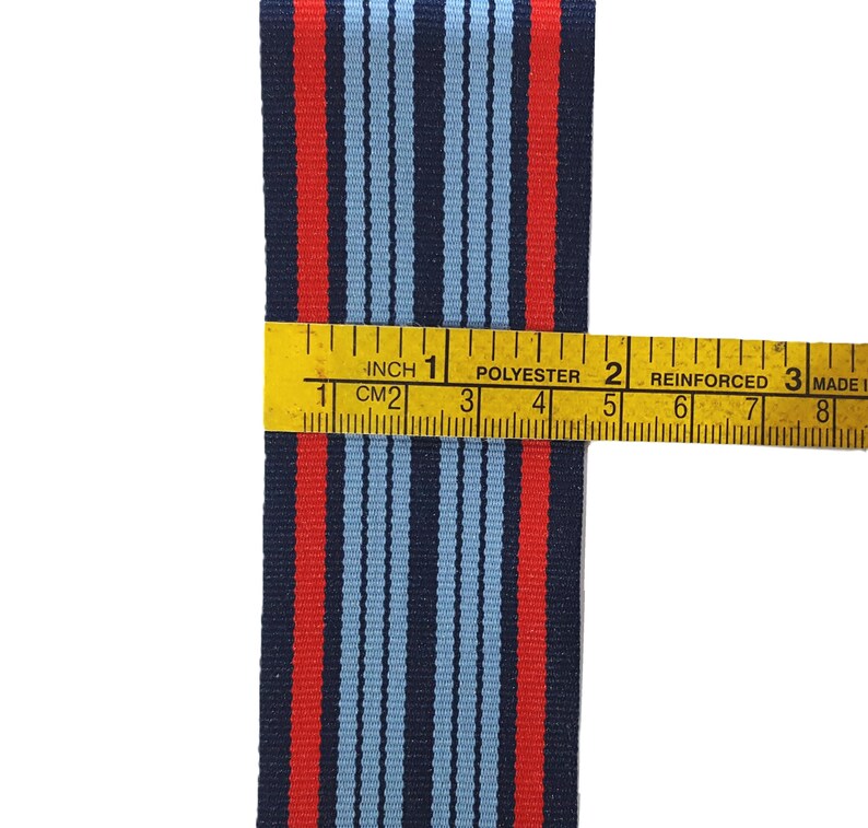 May include: Red, blue, and white striped ribbon measuring 1 inch wide. The ribbon is made of polyester and is reinforced.