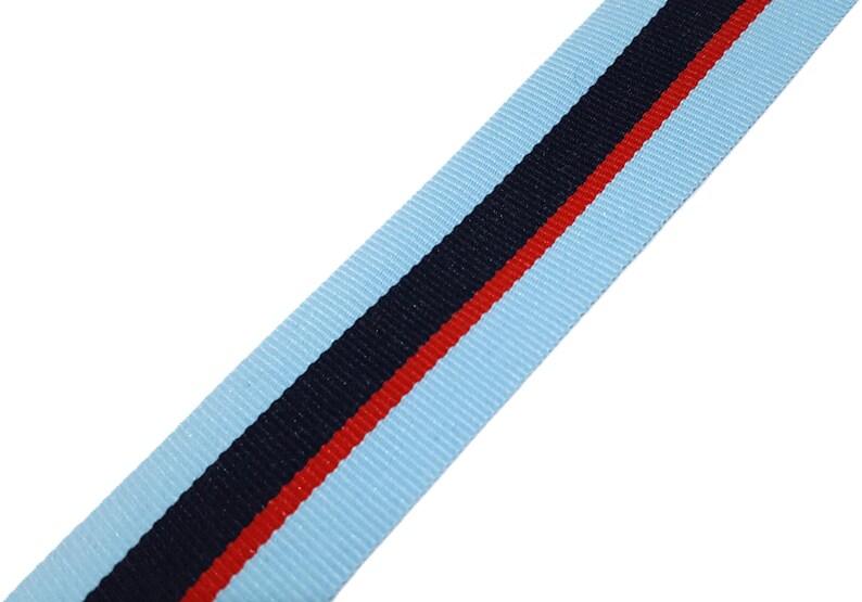 May include: Light blue ribbon with a black and red stripe.