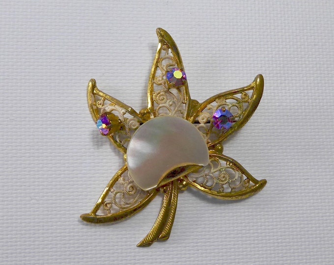 Enamelled brass watermark star brooch. 3/4 of a mother-of-pearl moon. Iridescent Rhine stone. Year 50.