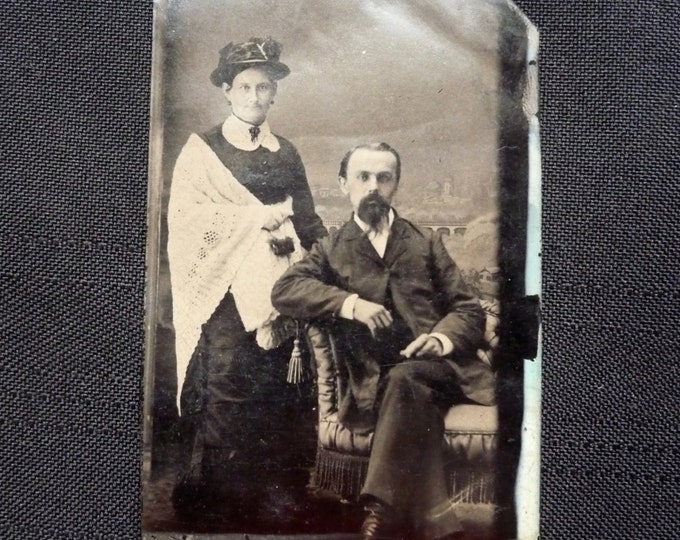 Ferrotype. Metal photo couple. Woman shawl, jewelry and hat. Man Goatee beard. 1860. Victorian era. Armchair. Buffalo Bill