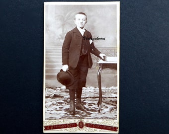 Photograph of a young boy, Edwardian period. 1900-10. Carte de visite. CDV. J.Hermans Neyt. Ghent, Belgium. Bowler hat. Gaiters.