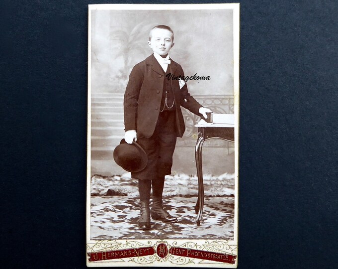 Photograph of a young boy, Edwardian period. 1900-10. Carte de visite. CDV. J.Hermans Neyt. Ghent, Belgium. Bowler hat. Gaiters.