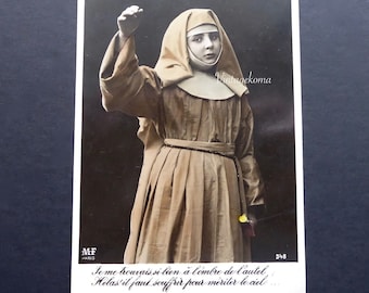 Religious postcard of a child. Nun. Glossy black and white photo. Colored. MF Paris. Cartophily. 1930. Crucifix. Rosary. Religious heritage