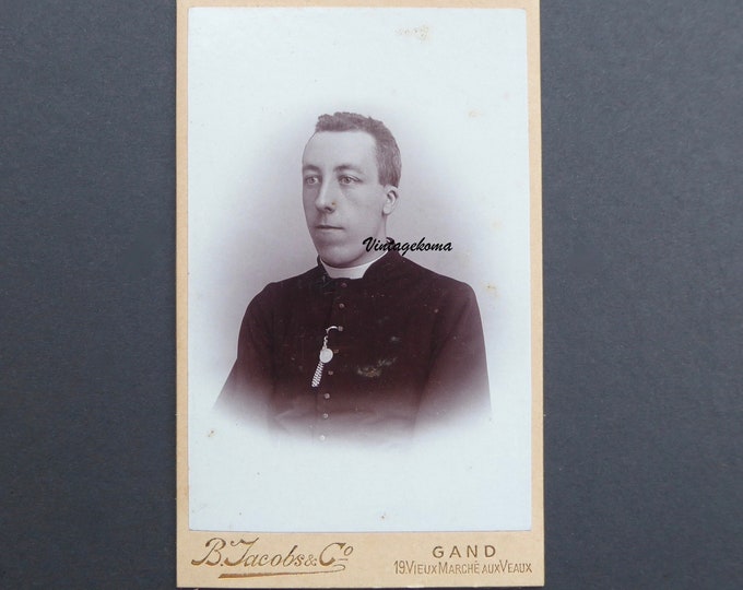 Photograph young priest 1900. CDV. B. Jacobs & Co. Ghent. Belgium. Cassock. Roman collar. Virgin Mary medallion