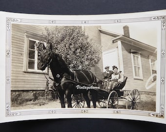 Vintage photo of a horse and carriage. Mother. Son. Central Quebec, 1938. Wooden house. Quebec countryside. Man's hat. Woman's hat.