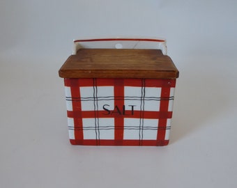 Wall salt box with burnt orange and black checkered pattern. Ceramic and wood. Japan. Year 50.