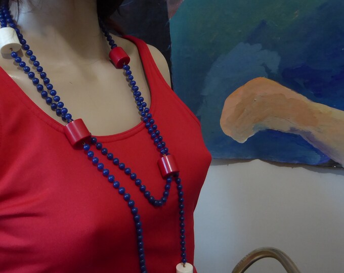 Red, blue and white long necklace with plastic ball and cylinder. 1970. Vintage long necklace.