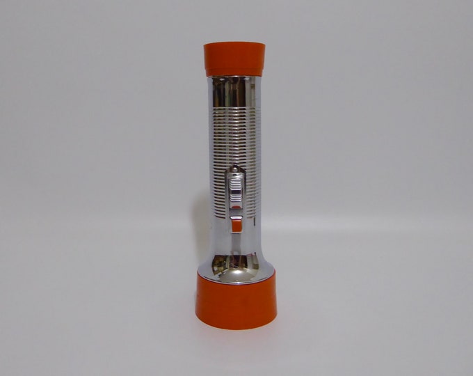 Vintage orange Balloon flashlight. 1970. Vintage flashlight. Vintage camping instrument. Design 1970.