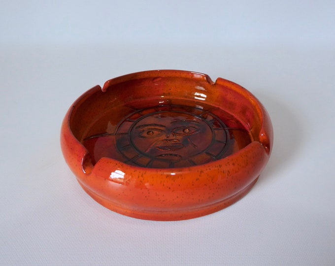 Round ashtray in orange glazed clay. 1970. Sun graphic. Seventies decor. Mid-century pottery.
