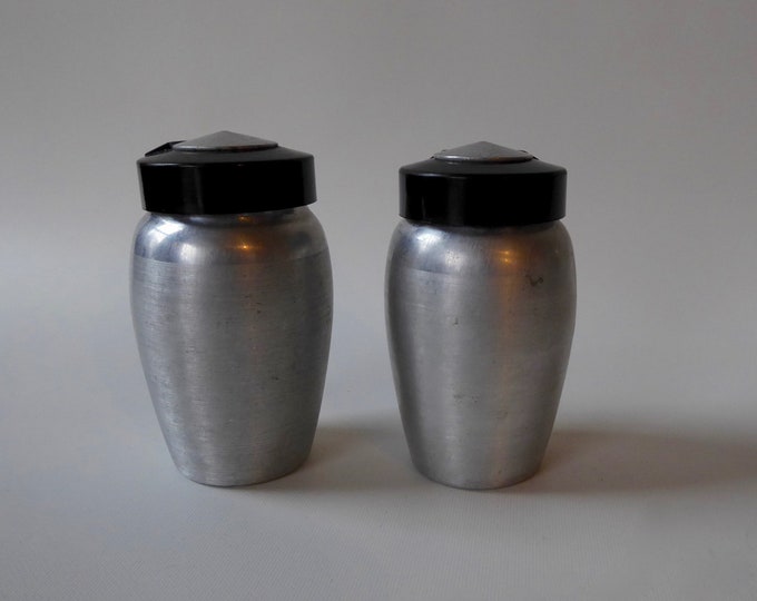 Kromex spice containers. Mustard. Cloves. Brushed aluminum and black plastic. 1950s. Retro kitchen. Bulk container. Slow food.