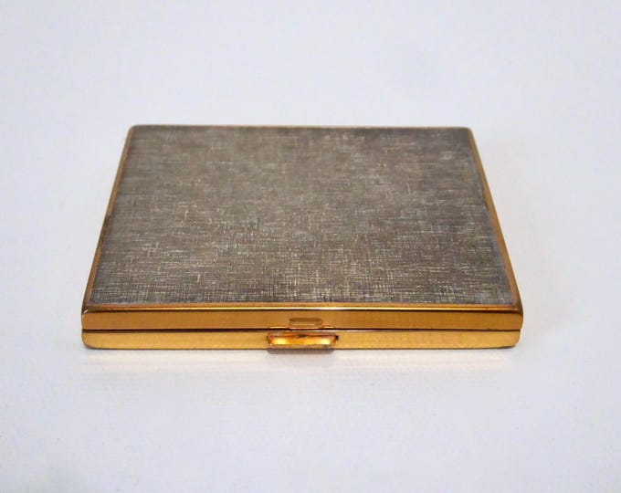 Vintage brass powder compact. Grey-tinted textured cover. Year 1970.