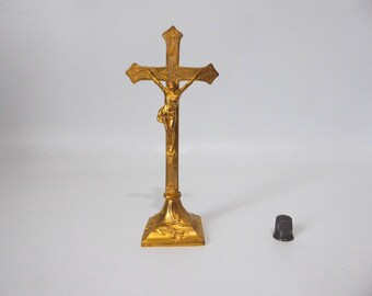 Crucifix on a metal stand with a gold cover. 1900. Vintage religious object.