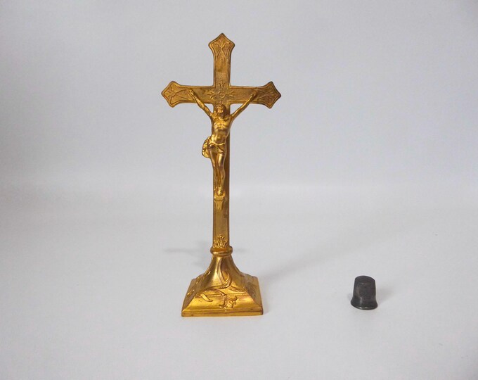 Crucifix on a metal stand with a gold cover. 1900. Vintage religious object.