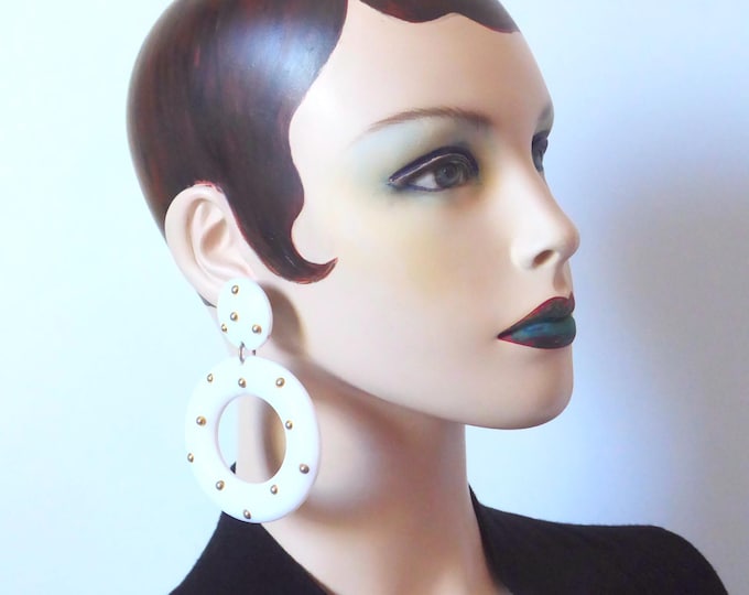 Mobile clip pendant with white plastic circle and brass ball. 1980.