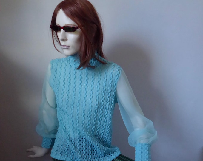 Long-sleeved blouse with a high collar. Year 1960.