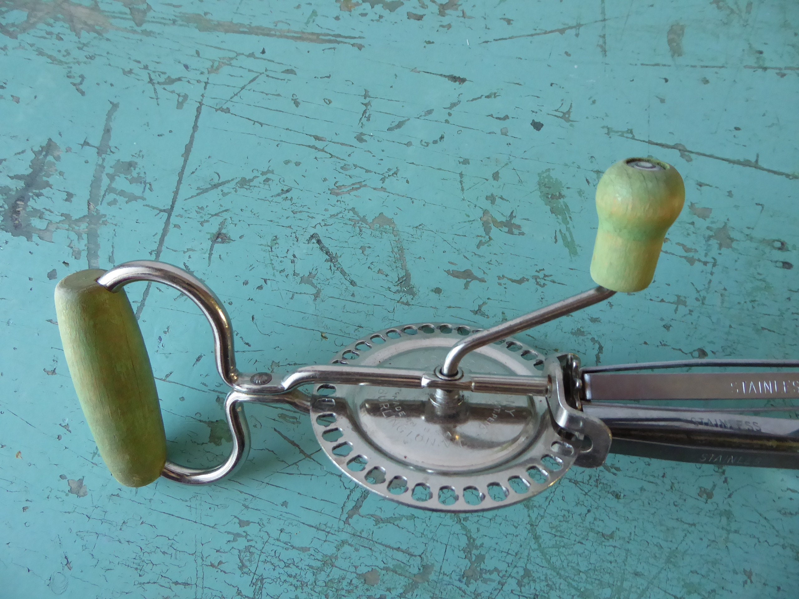 Manual egg beater. Green painted wooden handle. Edlund Company